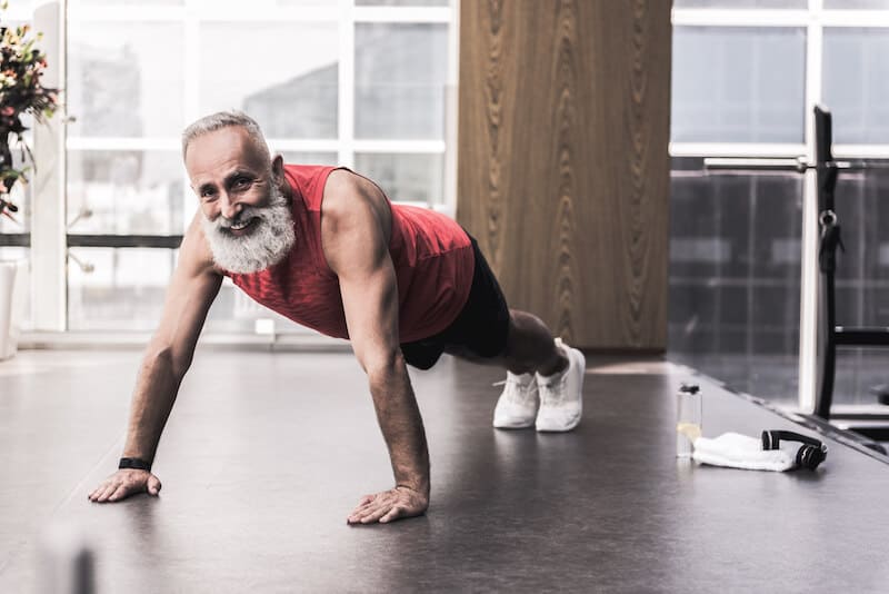 Older man doing a pushup at physical therapy