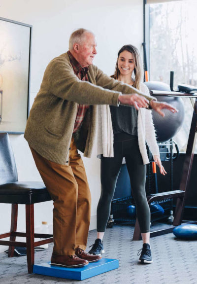 Physical therapist working with an older man on balance and falls prevention