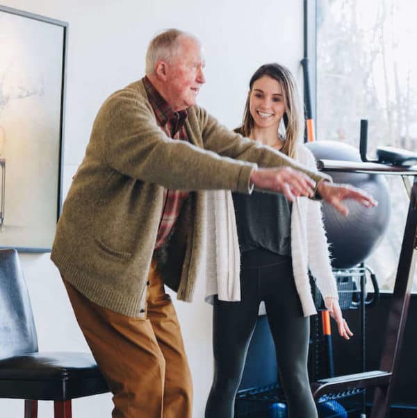 Physical therapist working with an older man on balance and falls prevention