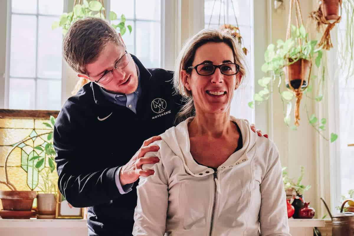 Physical therapist evaluating a woman's neck in her home in Arlington, Virginia