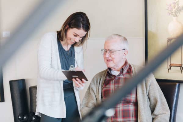 Physical therapist performing medical interview of geriatric man in Lake Oswego, Oregon