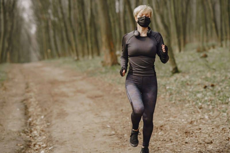 Physical therapy patient running in mask