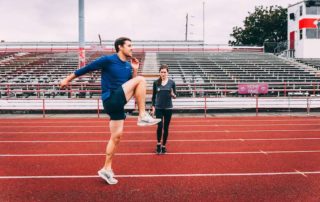 Man performing running drills on track