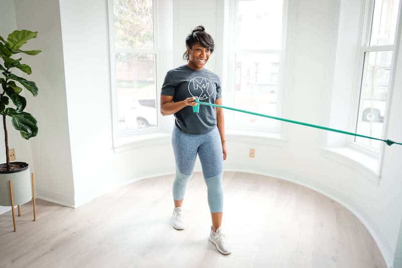 Woman exercising with bands for her shoulder pain while at physical therapy