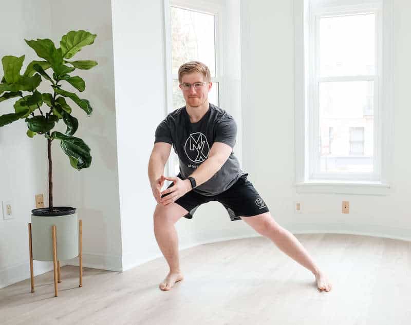 Man doing side lunge