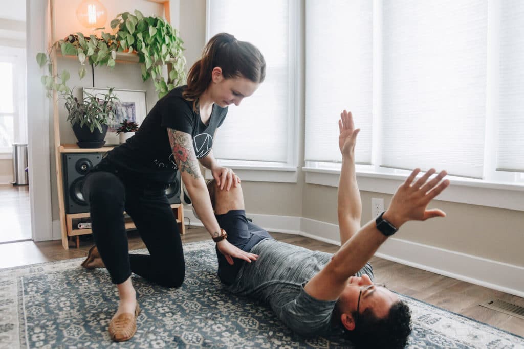 Physical Therapist teaching core exercise to patient with ehlers danlos syndrome in Portland, OR