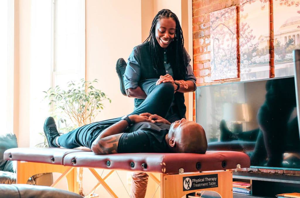 Physical therapist stretching patient with hypermobility syndrome in Portland, OR