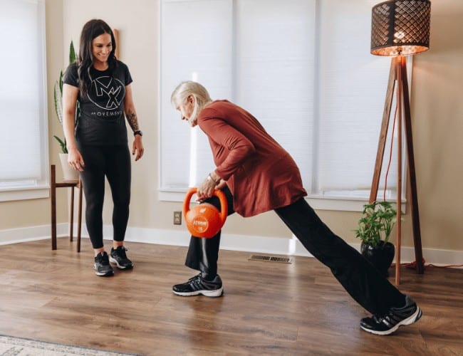 Dr. Katie Kuykendall working with an elderly patient on an independent exercise program.