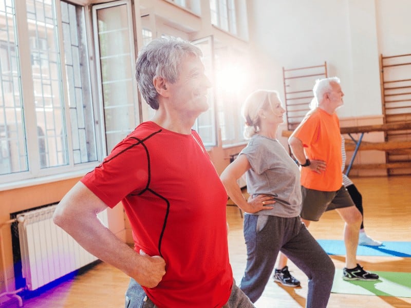 AgeProof Your Body older adults performing a forward lunge exercise