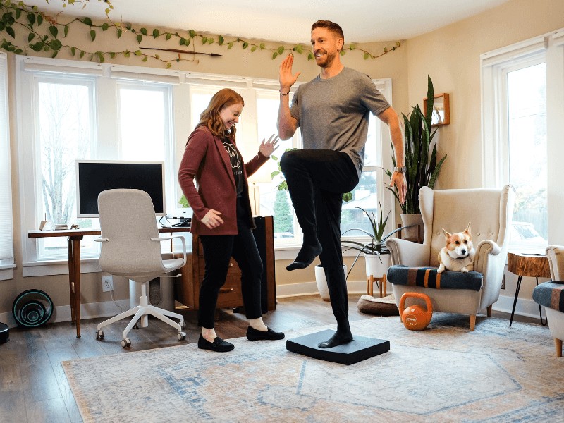 Dr. Sydney Neumann, PT, DPT helping a patient perform single leg balance exercises in Portland, Oregon.