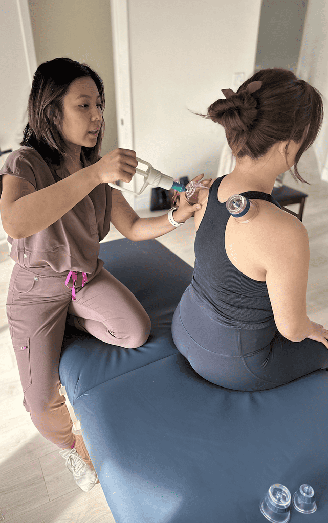 Marie Fernandez physical therapist with MovementX in orange county california providing cup therapy to a patient in Irvine CA