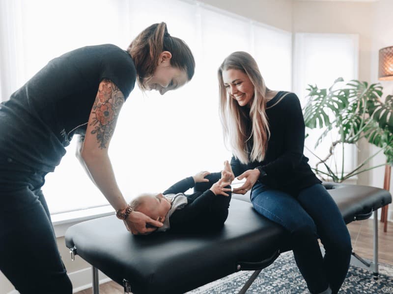 MovementX pelvic health physical therapist working with a new mother with her baby