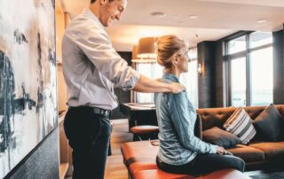 Physical therapist with MovementX scott mcafee treating an older adult patient with neck pain with personalized at home physical therapy treatment