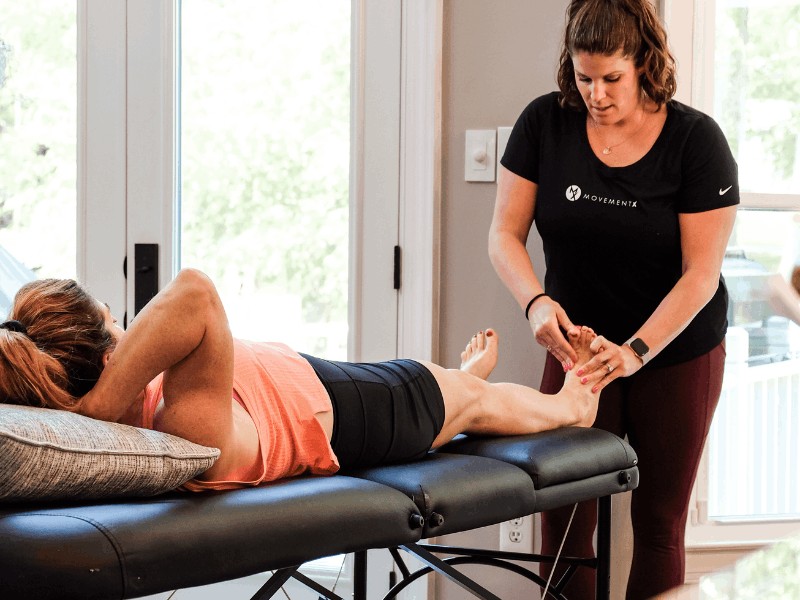 MovementX running physical therapist meg pezzino performing an injury assessment for plantar fasciitis on a runner