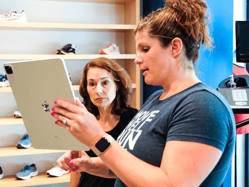 MovementX running physical therapist meg pezzino talking with a female runner in northern virginia about what the best running shoe is for her