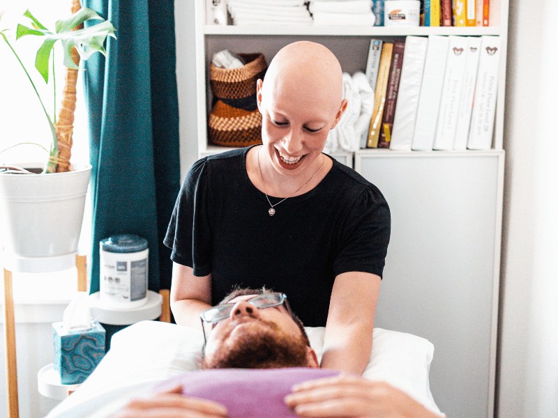 MovementX physical therapist Sarah Guenzburger giving a patient an initial assessment for ways physical therapy can help their neurological condition.