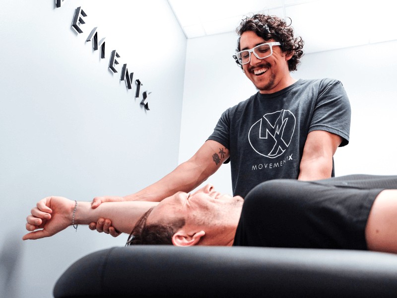 MovementX physical therapist Dr. Rich Ortiz, PT, DPT treating a patient in a MovementX treatment room in Washington, D.C.