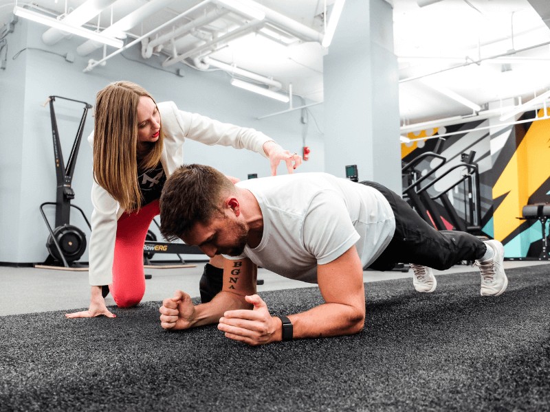 Dr. Stephanie Weyrauch, PT, DPT helping a client build better exercise habits during a workout.