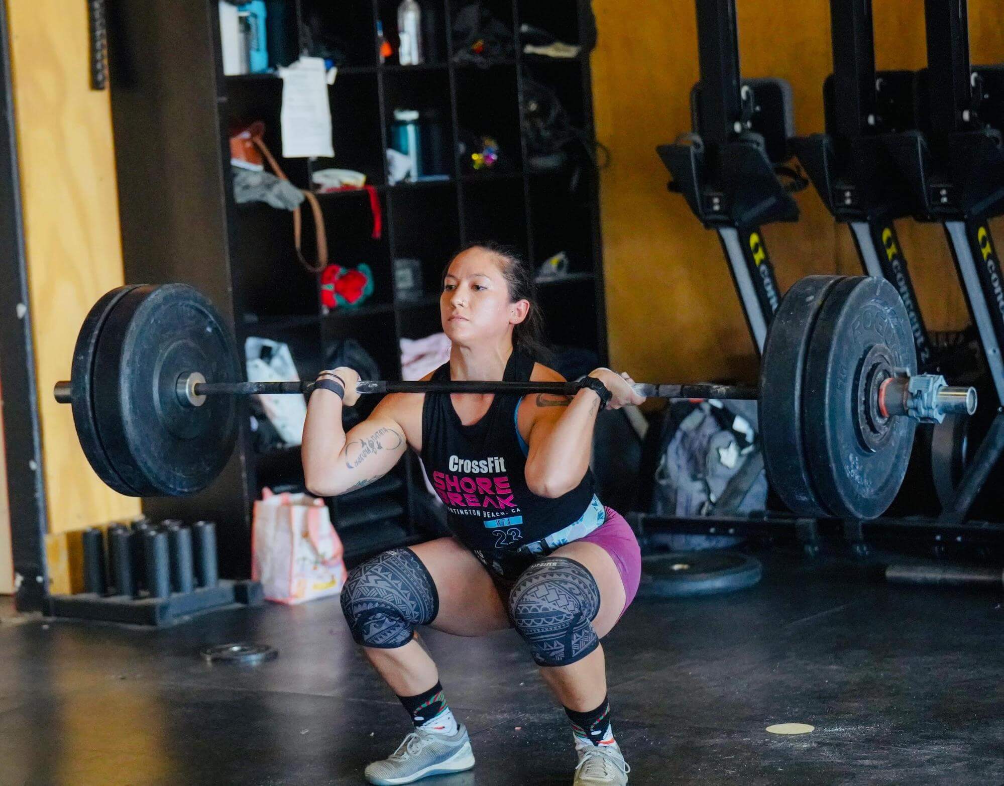 Dr. Jessica Crowder at the bottom of a barbell squat during a CrossFit workout in Orange County, CA.