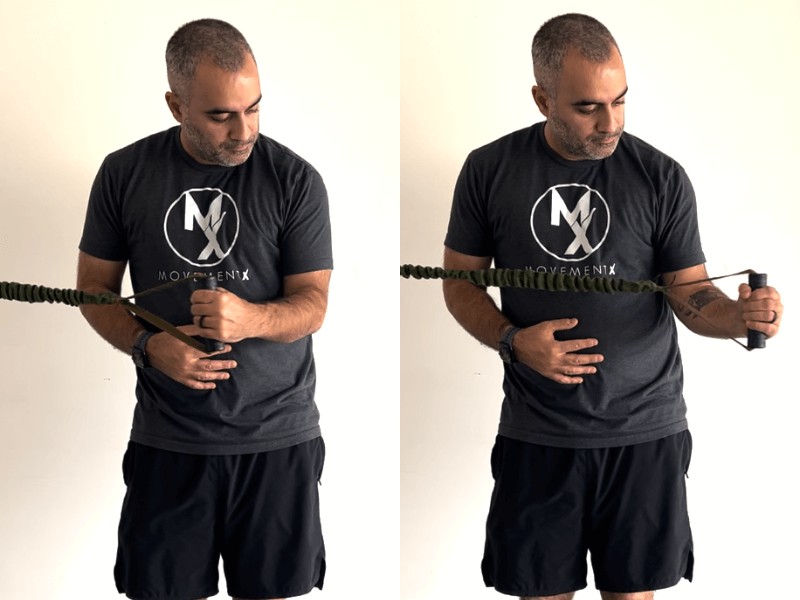 Dr. Romin Ghassemi, PT, DPT demonstrating an exterior banded shoulder rotation exercise, holding the band in his left hand with his left elbow anchored at his side, forearm out at a 90 degree angle, then rotating his left palm out while keeping his elbow in place.