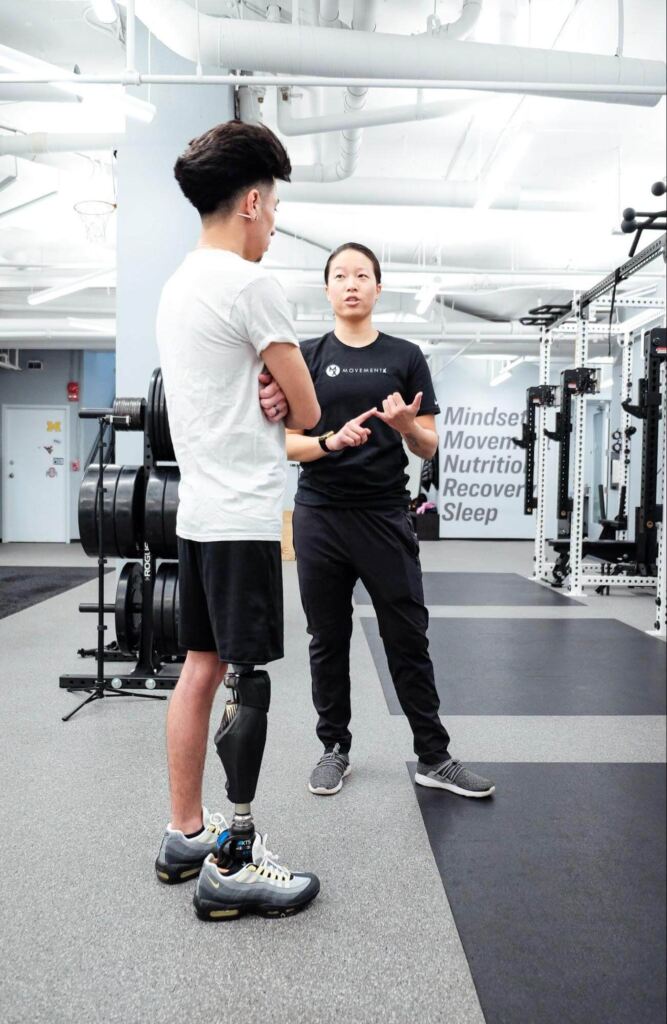 Dr. Audrey Chien consulting with a limb loss patient in a gym in Columbia, Maryland