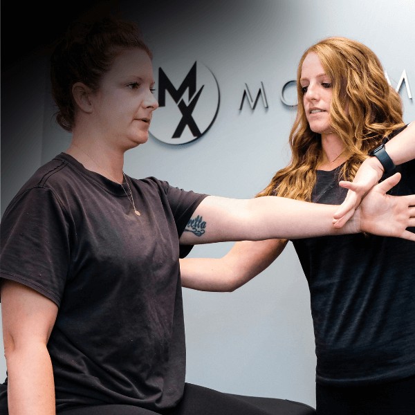 A MovementX orthopedic physical therapist helping a patient regain shoulder strength with tailored pre- and post-surgical rehabilitation exercises for faster recovery.