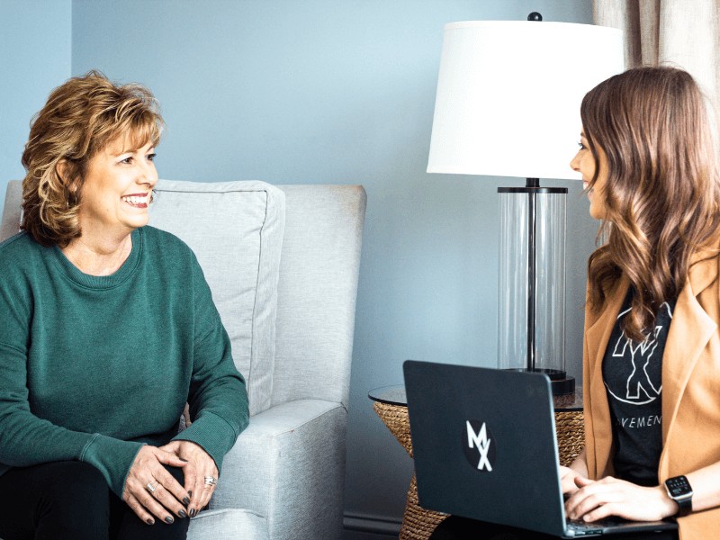 a movementx physical therapist conducting a subjective interview on a new senior female patient