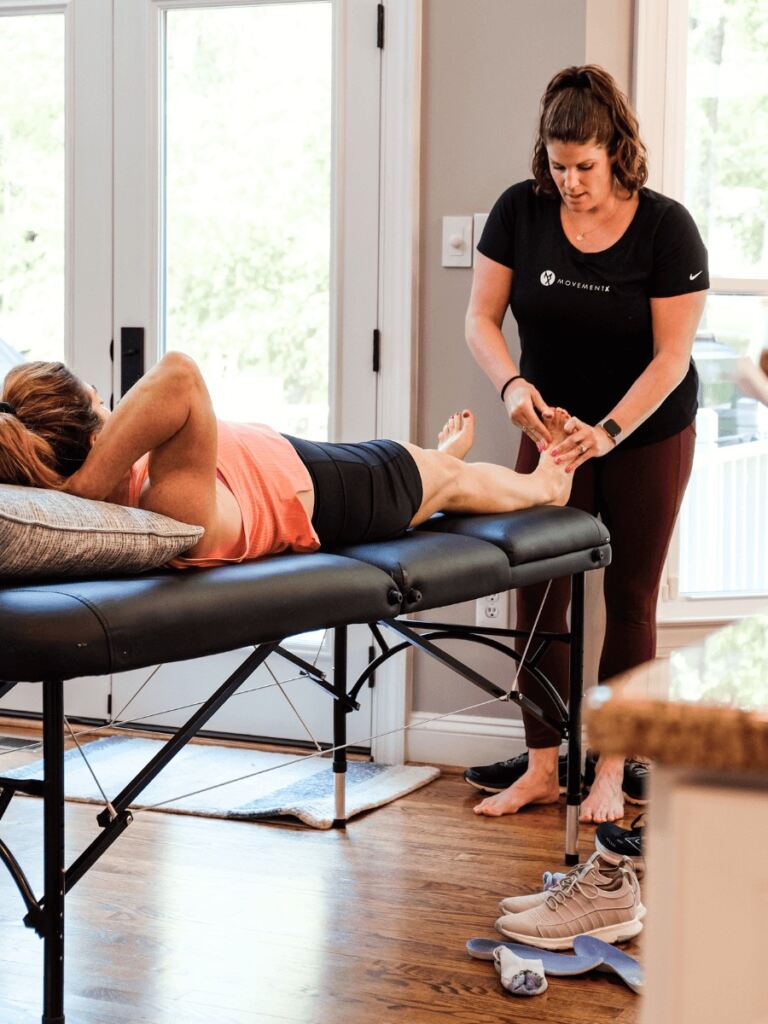 Meg Pezzino, PT, DPT helping a runner do physical therapy during a treatment.