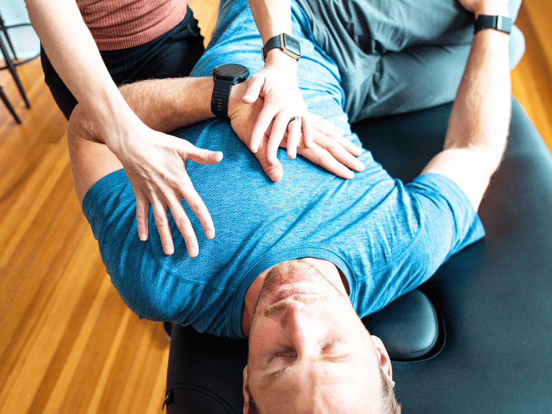 MovementX Provider Stephanie Weyrauch, PT, DPT assisting a patient in mobility work after a dry needling session.