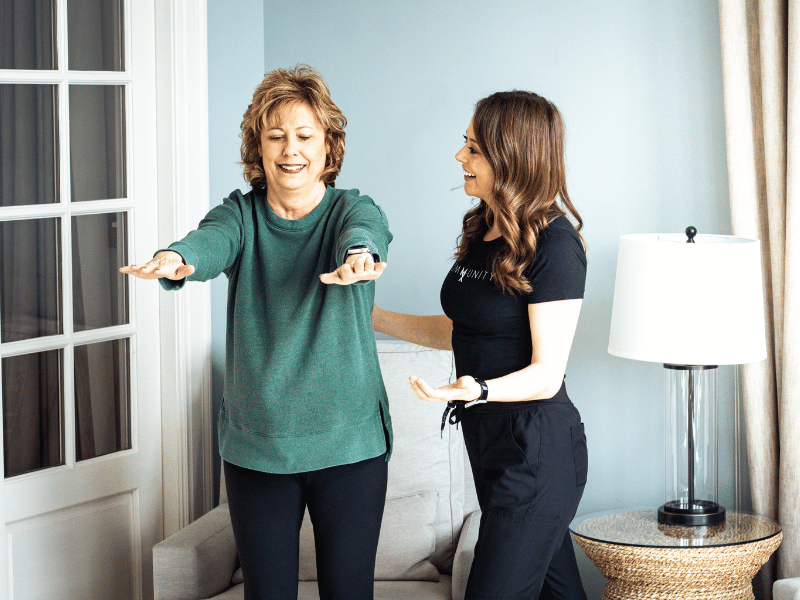 A MovementX provider providing help to a patient during a balance exercise for an in-home physical therapy session.