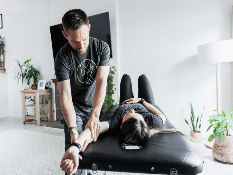 Adam Reinecker, PT, DPT helping a patient mobilize their frozen shoulder during an in-home care session in the Portland, Oregon area.