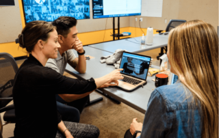 a group of three physical therapists applying for a PT job in oregon with MovementX in an office setting