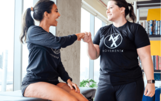 A movementx physical therapist in virginia enjoying her new PT job and celebrating with a patient in a clinic setting