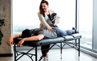 a movementx physical therapist in virginia enjoying her PT career in a clinic setting working with a patient with knee pain on a treatment table