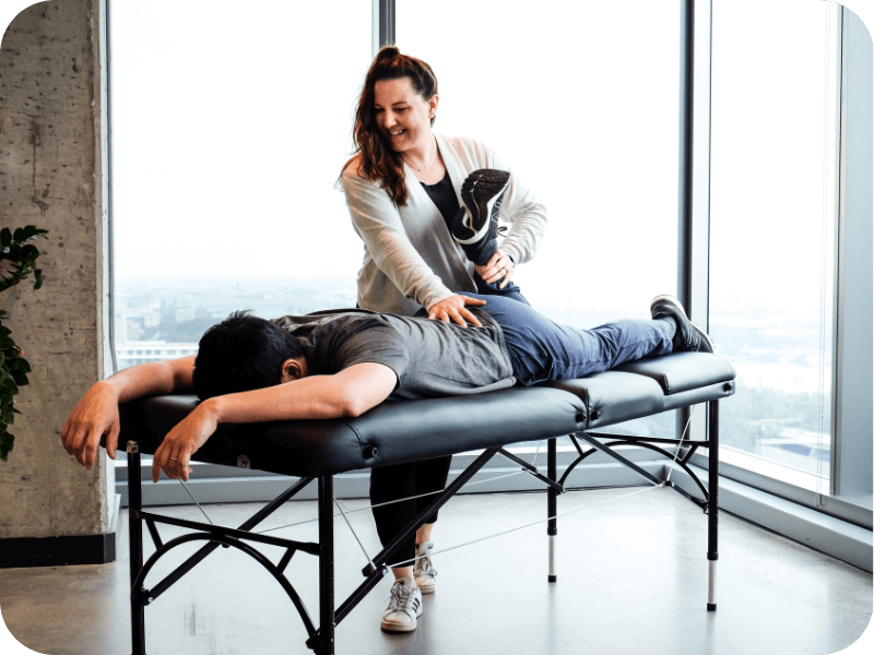 a movementx physical therapist in virginia enjoying her PT career in a clinic setting working with a patient with knee pain on a treatment table