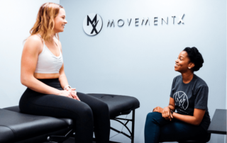 a movementx physical therapist in virginia talking with a patient in a clinic setting