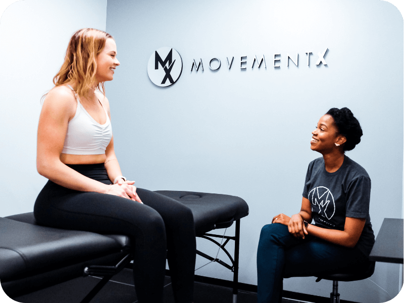 a movementx physical therapist in virginia talking with a patient in a clinic setting