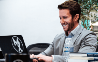 a movementx physical therapist learning how to perform his new PT job on a computer