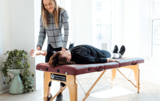 a movementx physical therapist in virginia working with a female patient in a bright home setting on a treatment table