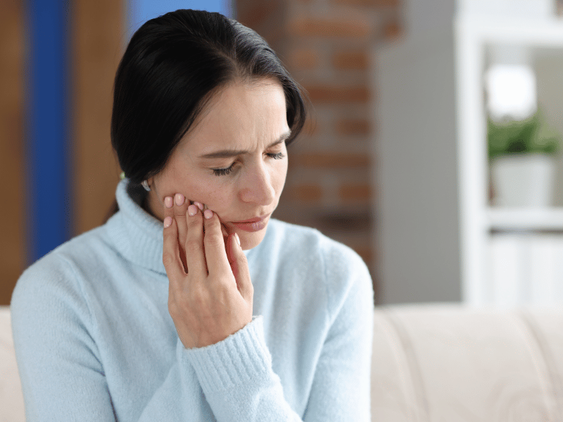 A woman dealing with TMJ pain.