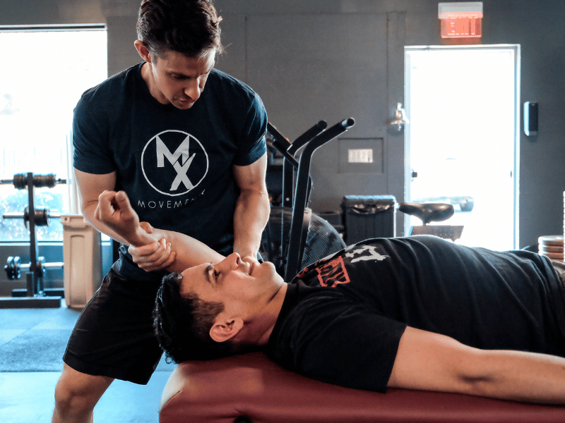 Dr. Dan Alcorn performing an overhead mobility test on a patient in Arlington, VA.