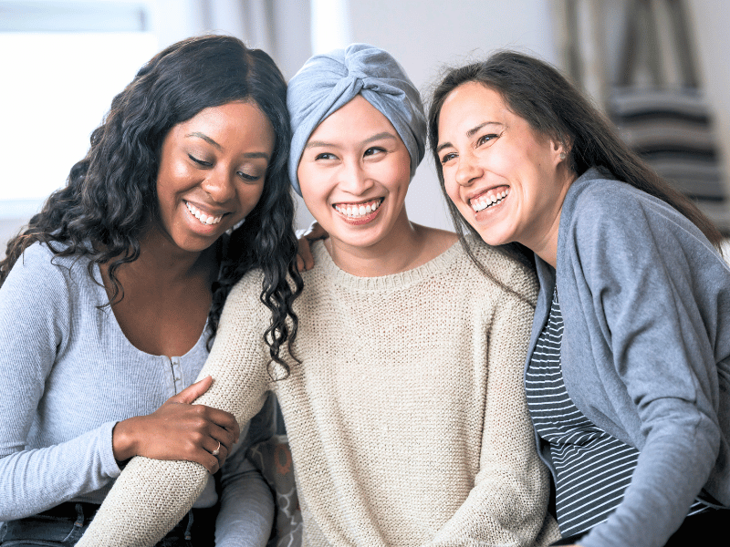 A group of women supporting a friend who is recovering from breast cancer treatment.