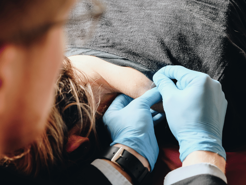 Fred Gilbert, PT, DPT performing a dry needling on a physical therapy patient in-home.