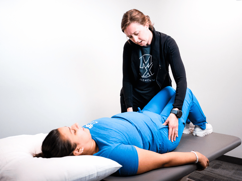 Elizabeth McGehee, PT, DPT helping a patient with interstitial cystitis in an evaluation.