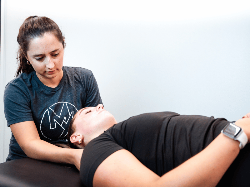 Bryn Bonner, PT, DPT helping a patient release their neck pain in a session in Washington, D.C.