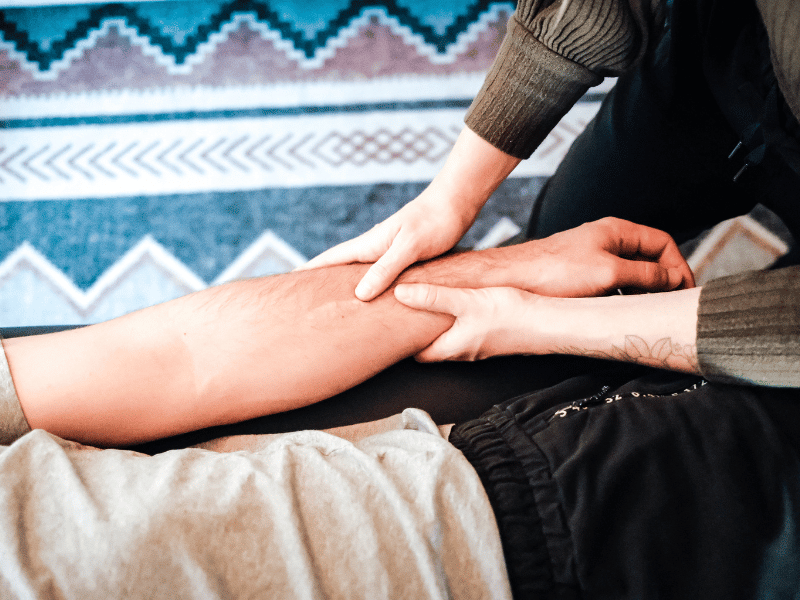 Morgan Stewart, PT, DPT helping a patient mobilize their forearm in Bend, Oregon.