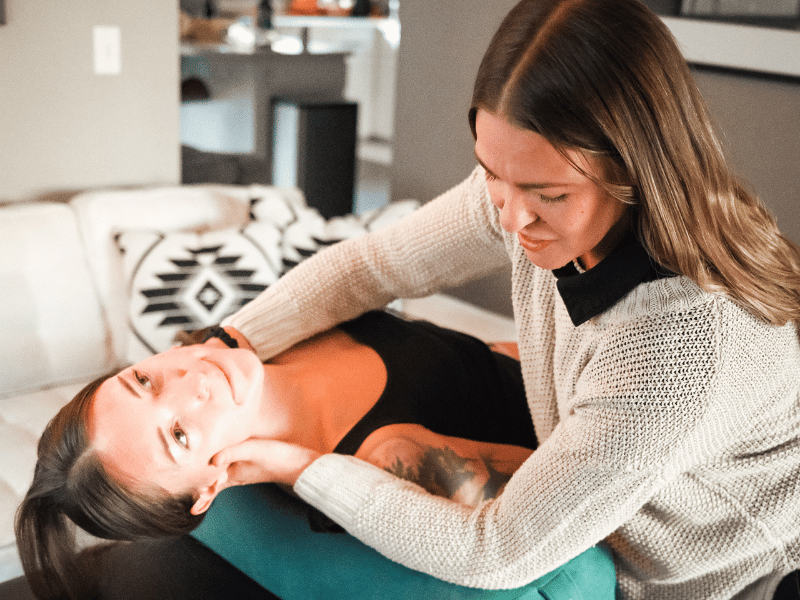 Morgan Stewart, PT, DPT helping a patient do lymphatic massage in an in-home session in Bend, Oregon.