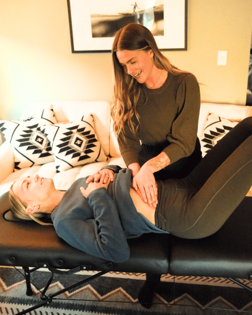 Morgan Stewart, PT, DPT helping a patient do lymphatic massage in an in-home session in Bend, Oregon.