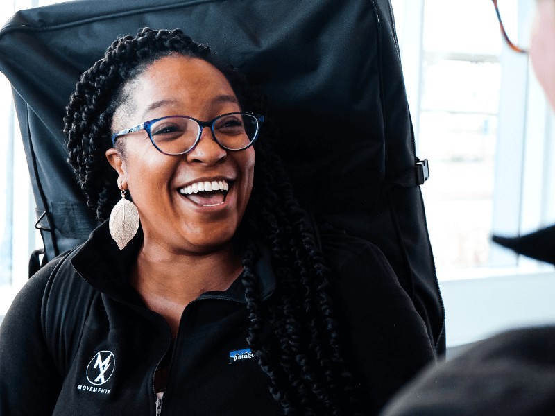 a female movementx concierge physical therapist smiling while greeting a new patient for the first time