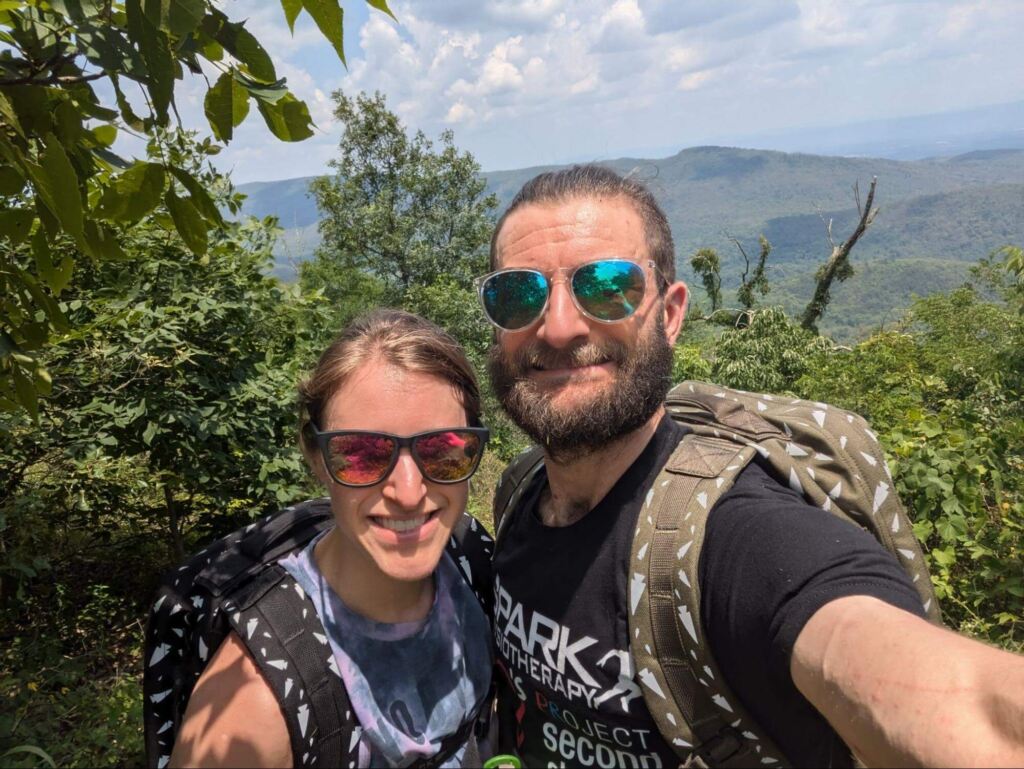 Dr. Matt Symanski taking a selfie of himself rucking in a forest.